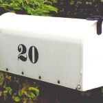A white mailbox with "20" printed on the side.