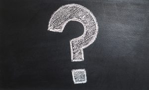 A big question mark on a black board.