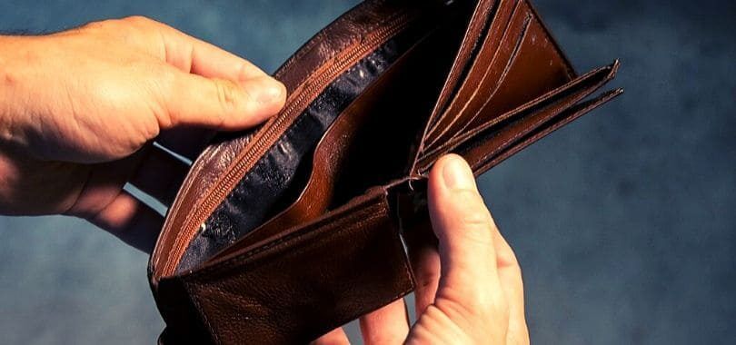 A student holding an empty wallet.