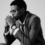 A black and white picture of a student thinking with their chin resting on their hands.