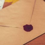 A brown letter with a red wax seal.