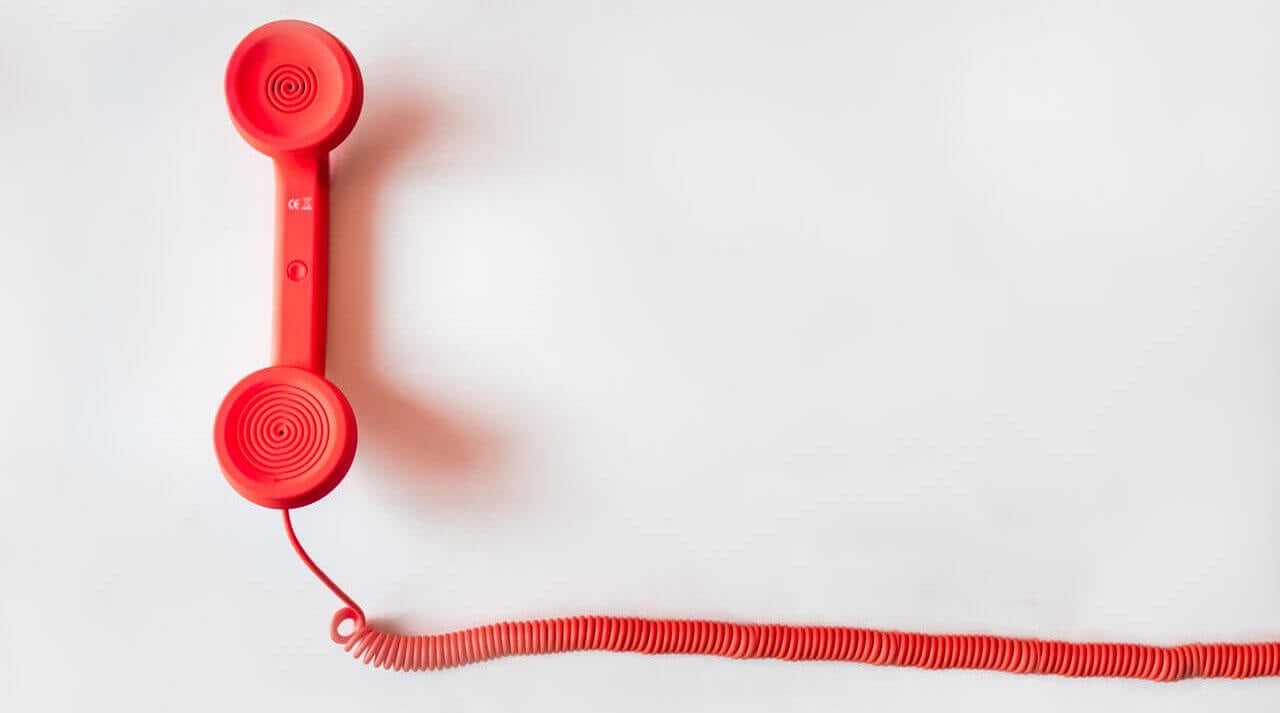Red phone handle with a cord.