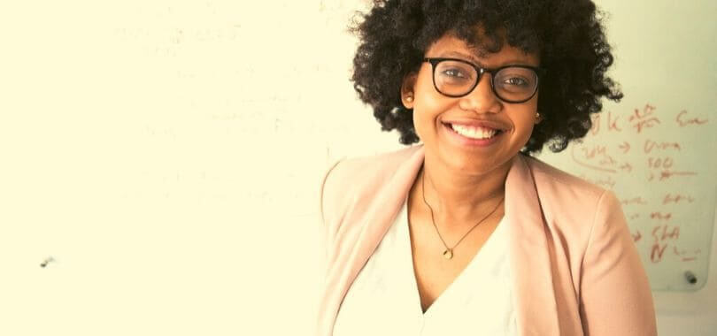 A teacher standing in front of a whiteboard.