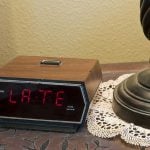 Digital alarm clock showing "late".