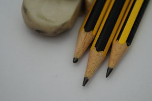 Three pencil head and dirty white eraser on a white background. 