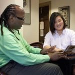 A professor and student talking at the library.