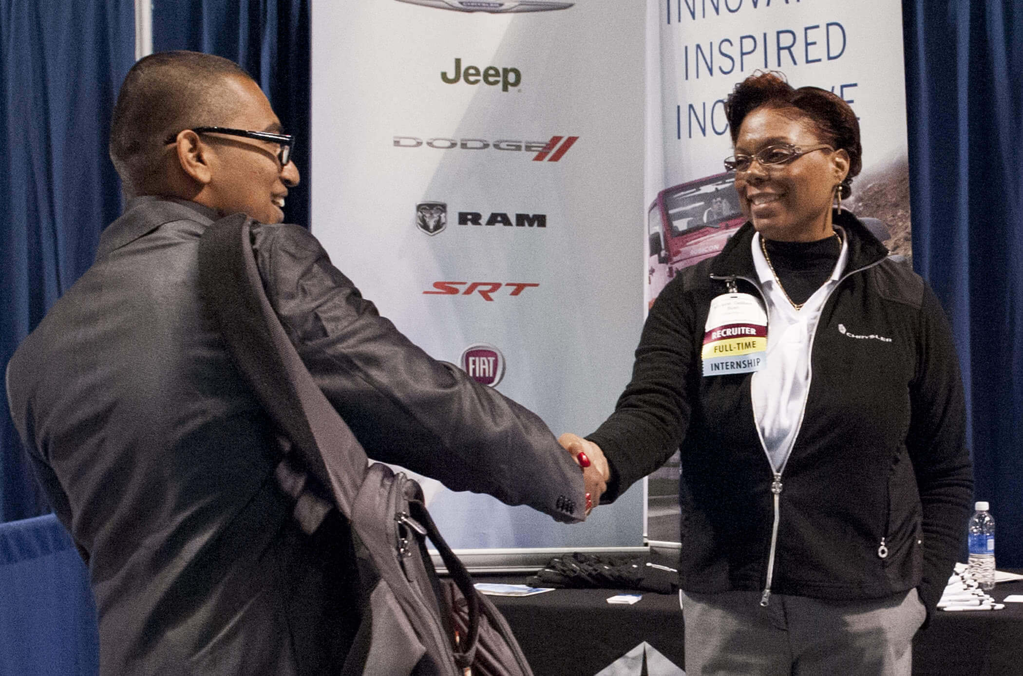 Man and woman shaking hands during Penn State Fall Career Days Fair.