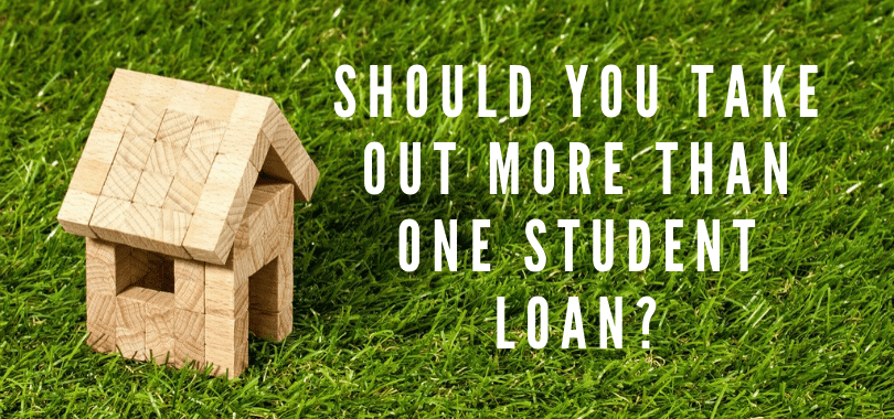 A small house made out of wooden blocks on grass, with text overlayed that says