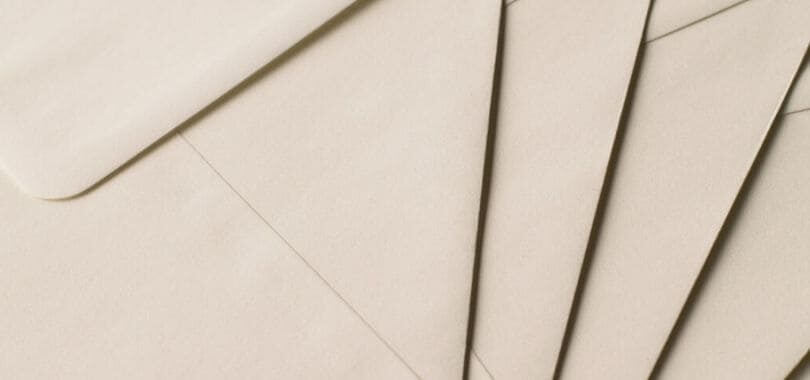 Beige envelopes stacked together.