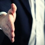 A business person offering a handshake.