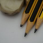 Three pencil head and dirty white eraser on a white background.