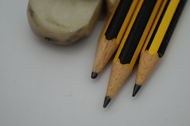 Three pencil head and dirty white eraser on a white background.