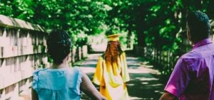 Parents walking behind their graduating student.