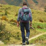 A student hiking in the hills during the summer.