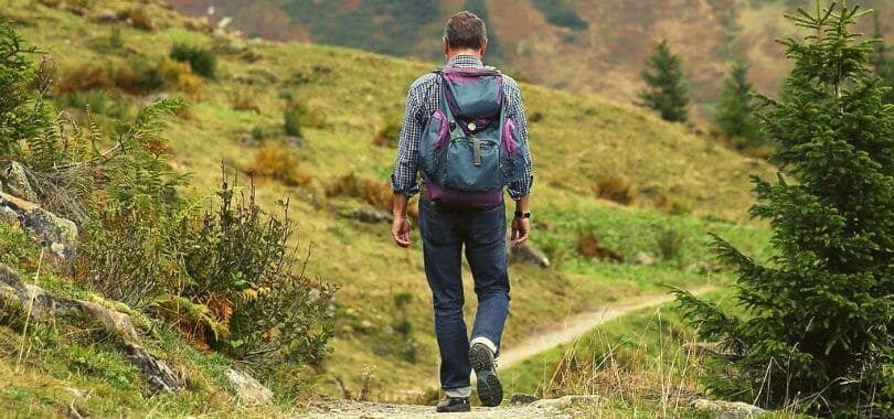 A student hiking in the hills during the summer.