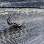 Hook on a piece of wood.