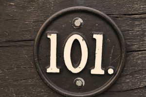 101 number in circular steel and is attached to wood.