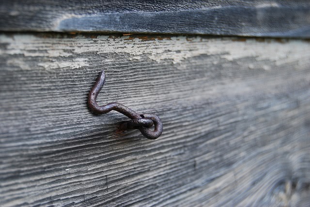 Hook on a piece of wood.