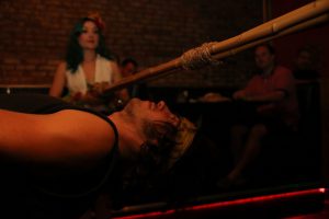 A man bent under the limbo stick.