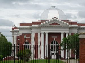 Tuskegee University campus building behind a black gate.