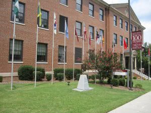 A North Carolina Central University building and flag poles in front.
