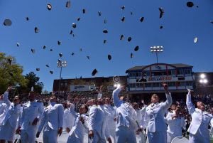 United States Coast Guard Academy Students tossing their hats in the air.