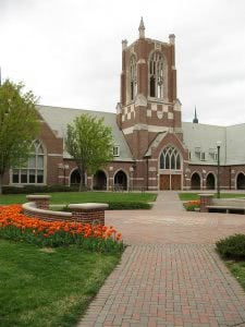 Jepson Hall in University of Richmond campus with orange flowers on the foreground.