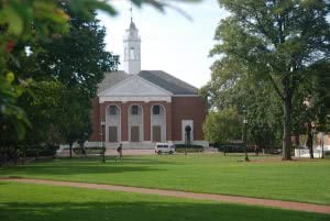 A building at Johns Hopkins University with a green lawn in front.