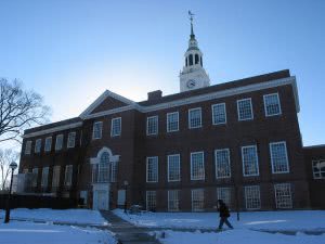 Dartmouth College campus building with snow-covered lawn.