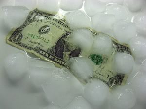 A dollar bill under melting ice cubes.