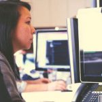 Two marketing people sitting at a computer.