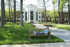 Student studying while sitting on a bench at Berry College.