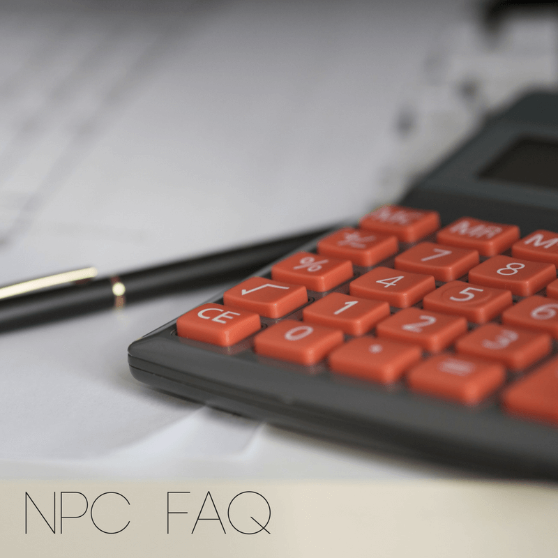 A black calculator with orange buttons showed in half. Black pen beside it.