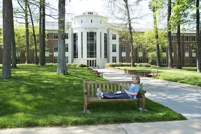 Student studying while sitting on a bench at Berry College.