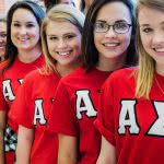 Alpha girls from Henderson State University are lining up and smiling.