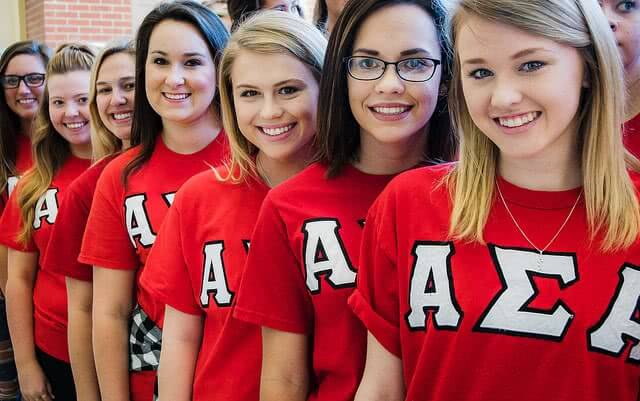 Alpha girls from Henderson State University are lining up and smiling.