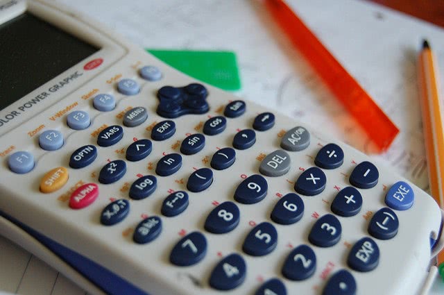 White calculator over a paper.