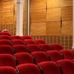 Rows of red theater seats.