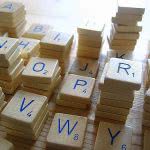 Letter tiles in scrabble game piled up.