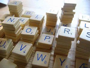 Letter tiles in scrabble game piled up.