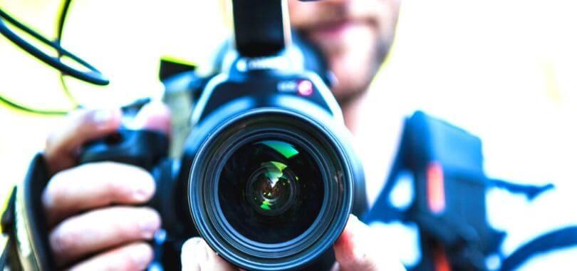 A college student holding a film camera.