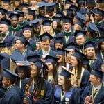 Crowd of student graduate class in caps and gowns.