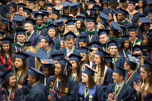 Crowd of student graduate class in caps and gowns.