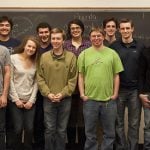 Students are posing in front of the chalkboard.