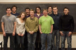 Students are posing in front of the chalkboard.