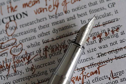 Like this pen and notes, proofreading your college essay can be messy but rewarding.
