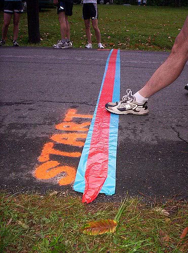 A foot stepping on the track line with the word