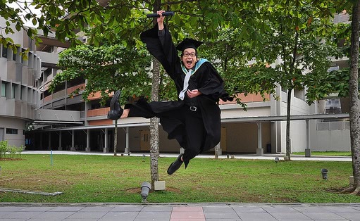 Graduate student jumps in excitement during his graduation day.