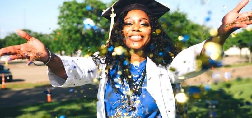 A graduating student throwing confetti.