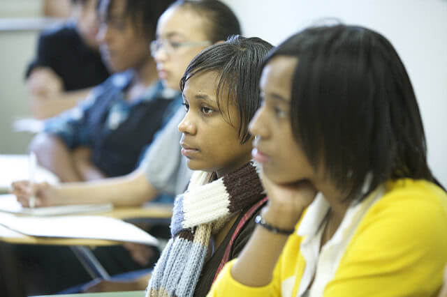 A group of students is sitting and facing to the left side.